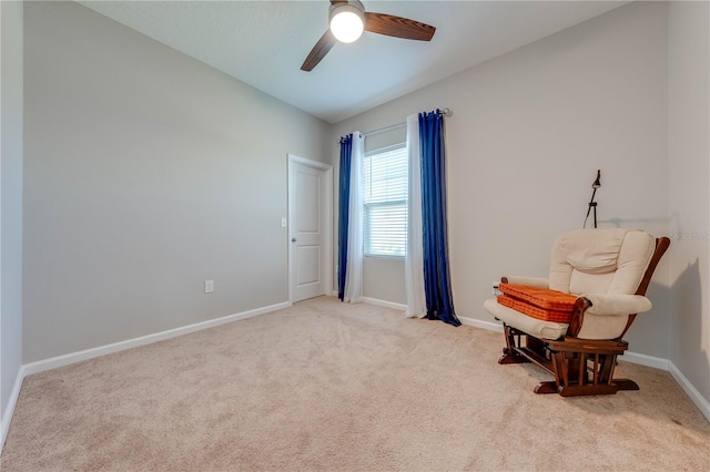 living area featuring lofted ceiling, ceiling fan, and light carpet