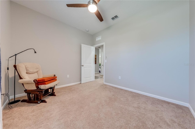 living area with light carpet, lofted ceiling, and ceiling fan