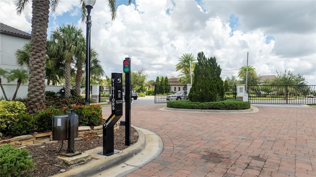 view of home's community featuring a gate and fence