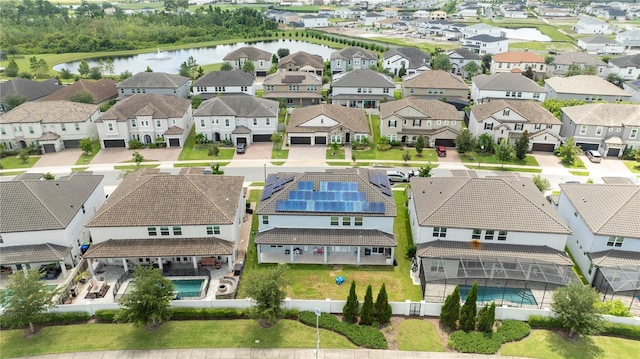 drone / aerial view featuring a water view and a residential view