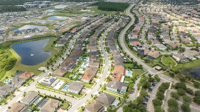 drone / aerial view featuring a water view and a residential view