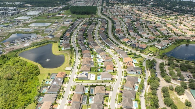 drone / aerial view with a water view and a residential view