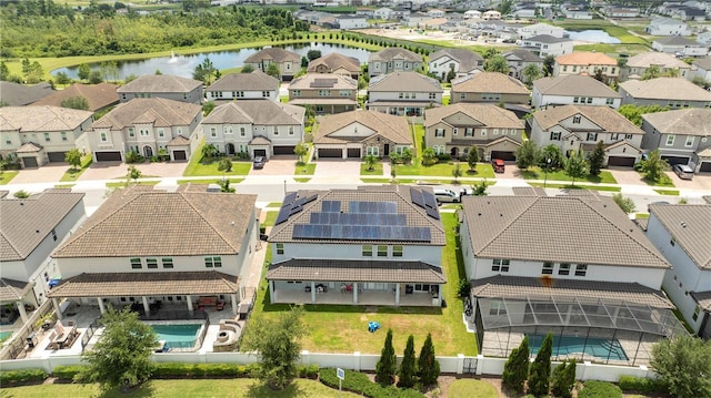 drone / aerial view with a residential view and a water view