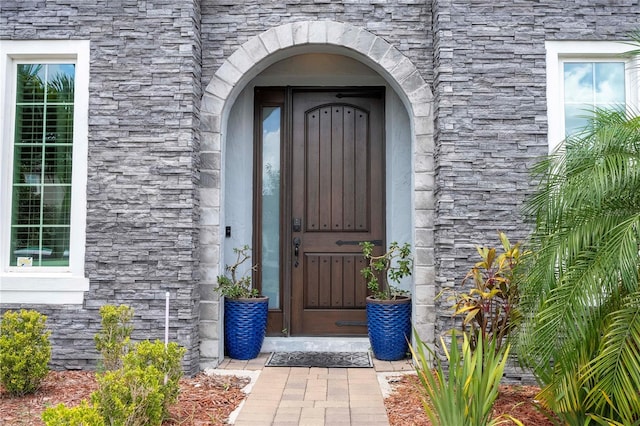 property entrance with stone siding