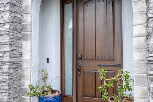 view of exterior entry featuring stone siding