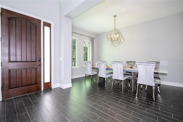 dining area featuring an inviting chandelier, wood tiled floor, and baseboards