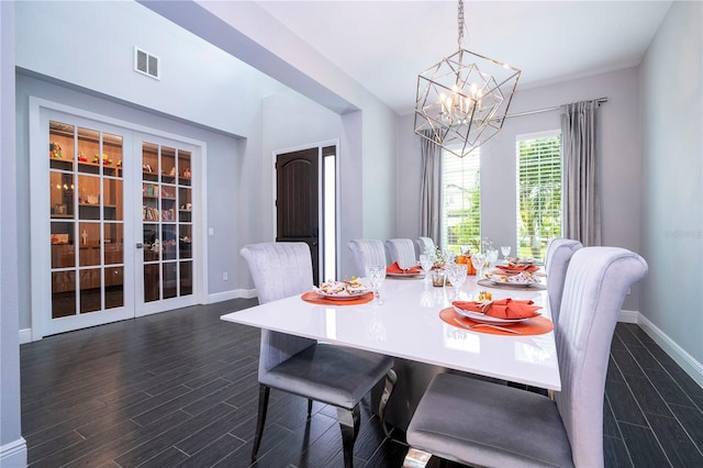 dining room with a chandelier, french doors, dark wood-style flooring, and baseboards