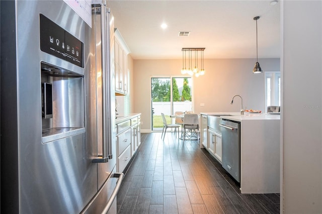 kitchen with white cabinets, dishwasher, refrigerator, light countertops, and a sink