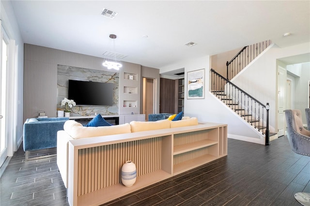 living area with baseboards, stairway, visible vents, and wood tiled floor