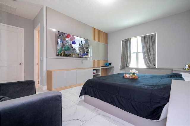 bedroom with marble finish floor, visible vents, and baseboards