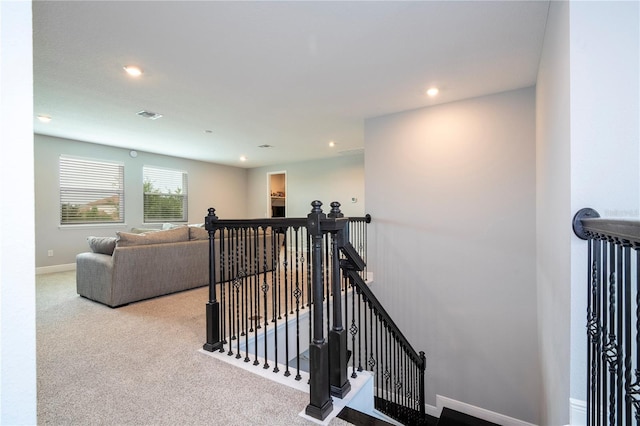 stairway featuring visible vents, baseboards, carpet flooring, and recessed lighting