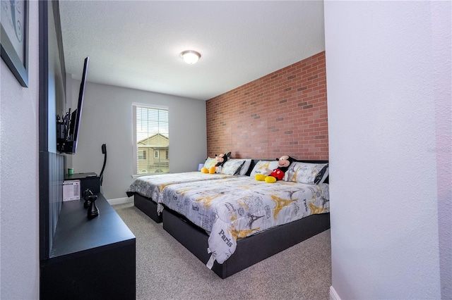 bedroom with brick wall, carpet, and baseboards