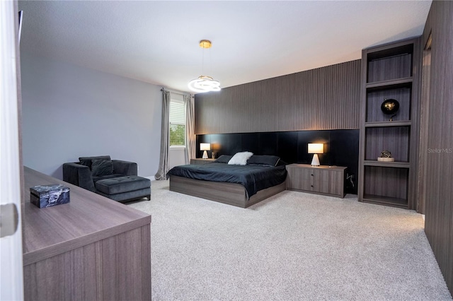 bedroom with an accent wall and carpet flooring