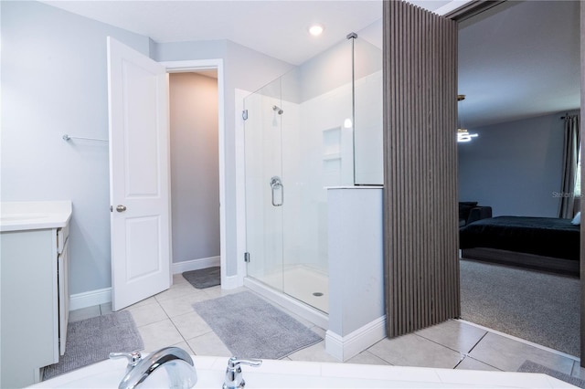 bathroom with baseboards, a stall shower, ensuite bath, and tile patterned floors