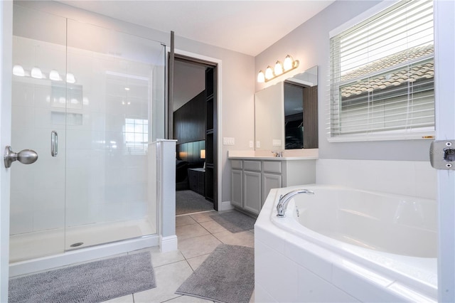 bathroom featuring a shower stall, vanity, a bath, and tile patterned floors