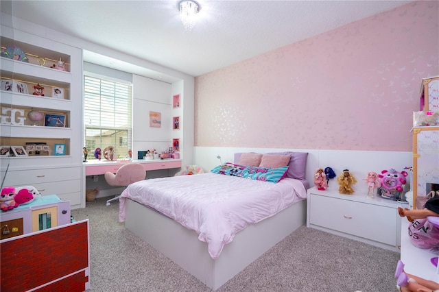 bedroom with carpet floors and wallpapered walls