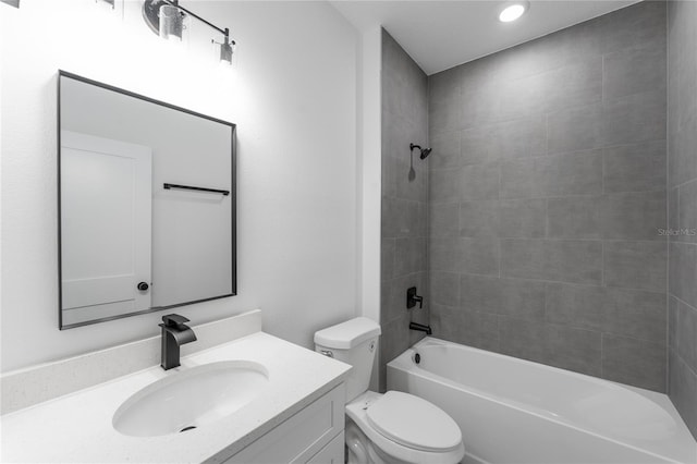 full bathroom featuring vanity, toilet, and tiled shower / bath combo