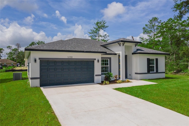 view of front of home with a front lawn and a garage