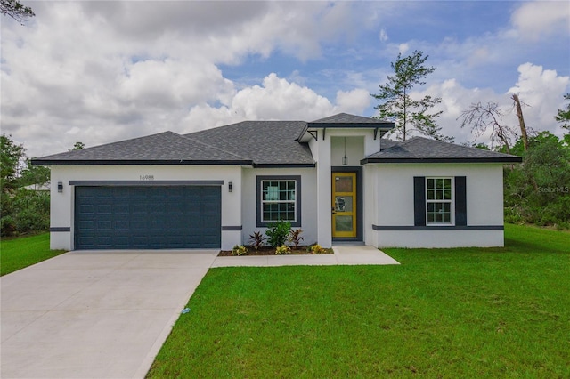 prairie-style home featuring a garage and a front yard