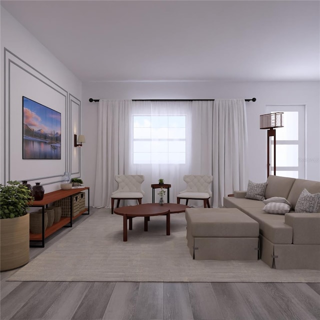 living room featuring a wealth of natural light and light hardwood / wood-style flooring