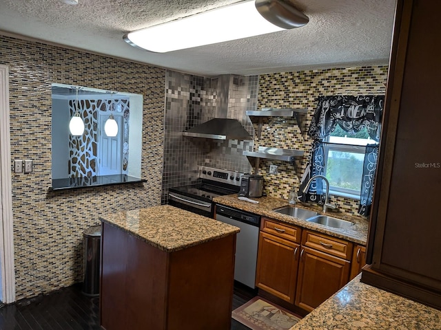 kitchen featuring sink, tile walls, a kitchen island, stainless steel appliances, and wall chimney range hood