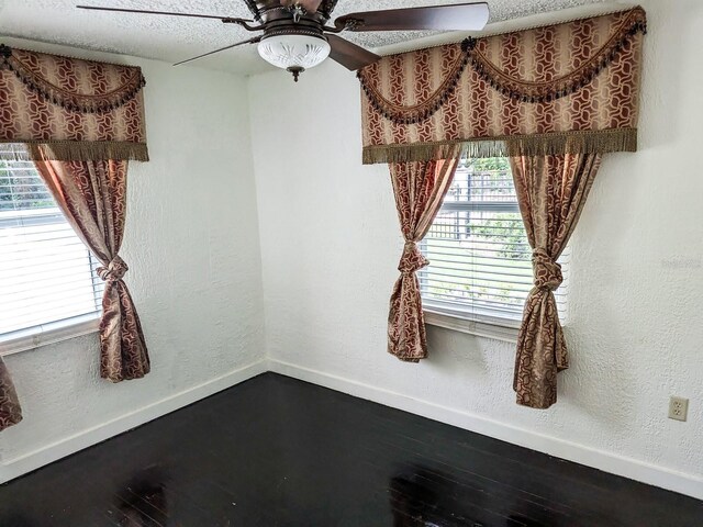 interior space with ceiling fan and a textured ceiling