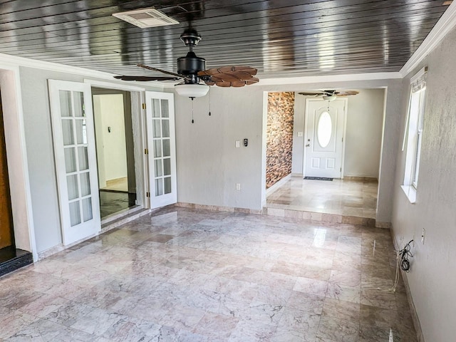 interior space with tile patterned flooring, ceiling fan, ornamental molding, and french doors