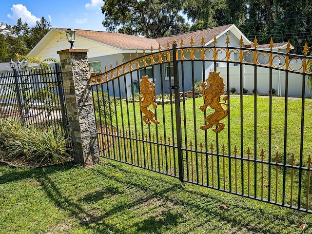 view of gate featuring a yard