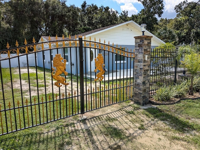 view of gate with a lawn