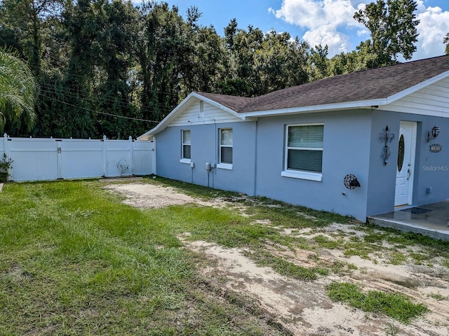 view of property exterior featuring a lawn