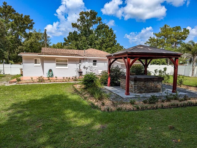 exterior space featuring a yard and a gazebo