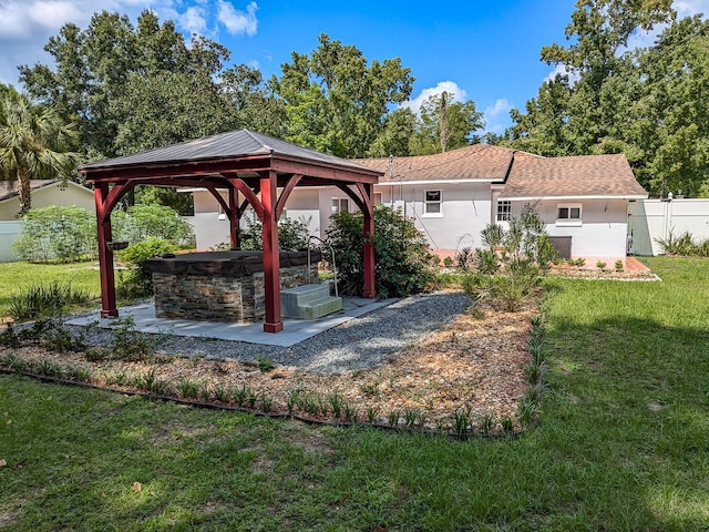 exterior space with a gazebo, a patio, and a lawn