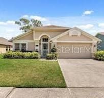 view of front of house with a garage, a front lawn, and concrete driveway