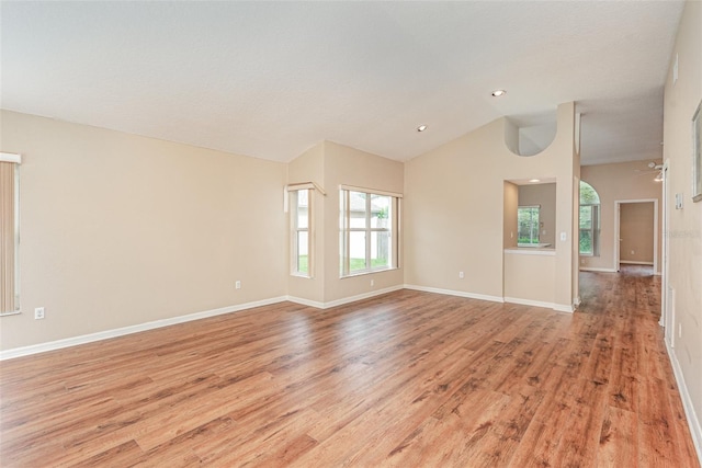 spare room with light wood finished floors, baseboards, recessed lighting, a ceiling fan, and vaulted ceiling