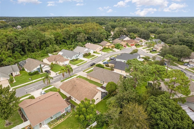 aerial view featuring a wooded view and a residential view