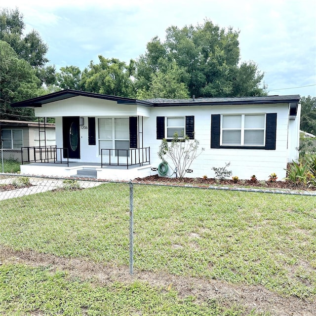 ranch-style house with a front lawn and covered porch