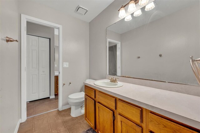 bathroom with tile patterned floors, toilet, and vanity