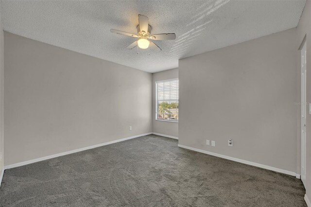 unfurnished room featuring ceiling fan, a textured ceiling, and dark colored carpet