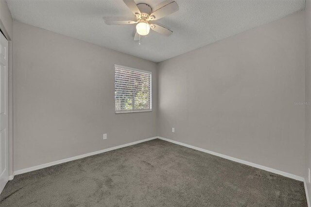 carpeted empty room with ceiling fan and a textured ceiling