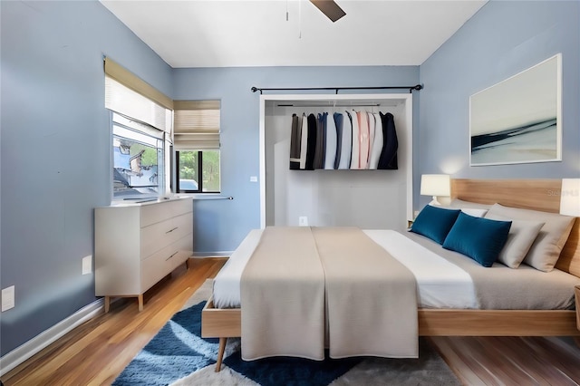 bedroom with light wood-type flooring and ceiling fan