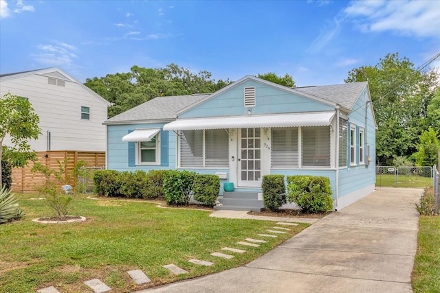 bungalow-style house with a front lawn