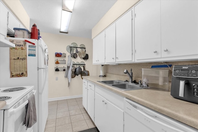 kitchen featuring backsplash, sink, white appliances, light tile patterned floors, and white cabinets