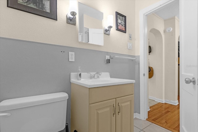 bathroom featuring toilet, vanity, and tile patterned floors