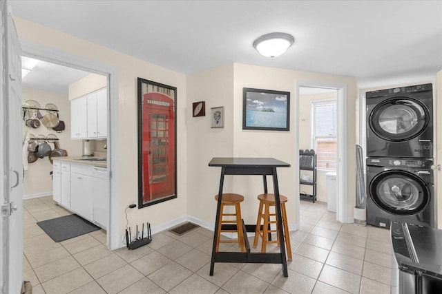 interior space featuring stacked washer and clothes dryer