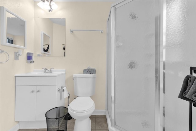 bathroom featuring toilet, vanity, walk in shower, and tile patterned floors