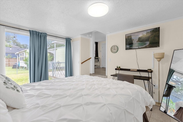 tiled bedroom with crown molding and a textured ceiling