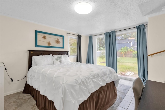 bedroom with multiple windows, a textured ceiling, and light tile patterned flooring