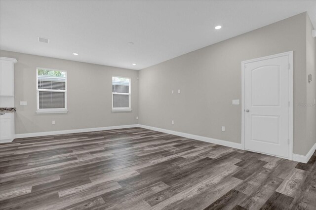 unfurnished living room featuring dark wood-type flooring