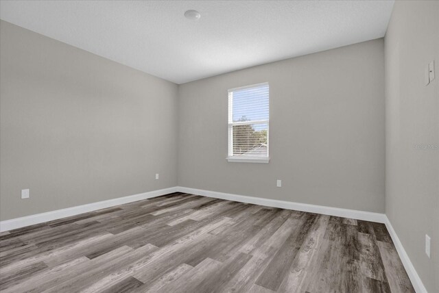 spare room with hardwood / wood-style floors