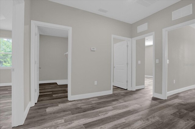 unfurnished room with dark hardwood / wood-style flooring